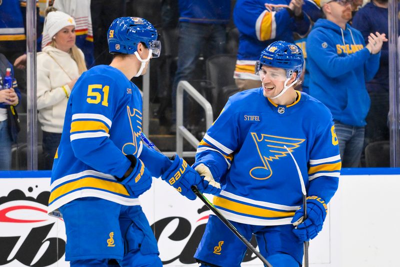 Nov 28, 2025; St. Louis, Missouri, USA; St. Louis Blues defenseman Matthew Kessel (51) celebrates with left wing Dylan Holloway (81) after scoring against the Ottawa Senators during the third period at Enterprise Center. Mandatory Credit: Jeff Curry-Imagn Images