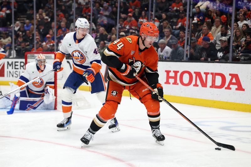 Mar 4, 2026; Anaheim, California, USA;  Anaheim Ducks left wing Ross Johnston (44) controls the puck against New York Islanders defenseman Matthew Schaefer (48) during the second period at Honda Center. Mandatory Credit: Kiyoshi Mio-Imagn Images