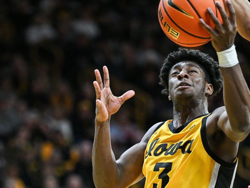 Dec 3, 2024; Iowa City, Iowa, USA; Iowa Hawkeyes guard Drew Thelwell (3) goes to the basket against the Northwestern Wildcats during the second half at Carver-Hawkeye Arena. Mandatory Credit: Jeffrey Becker-Imagn Images