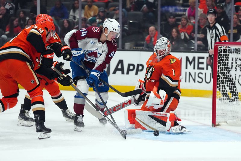 Apr 13, 2025; Anaheim, California, USA; Anaheim Ducks goaltender Lukas Dostal (1) and defenseman Pavel Mintyukov (34) defend the goal against Colorado Avalanche left wing Joel Kiviranta (94) in the first period at Honda Center. Mandatory Credit: Kirby Lee-Imagn Images