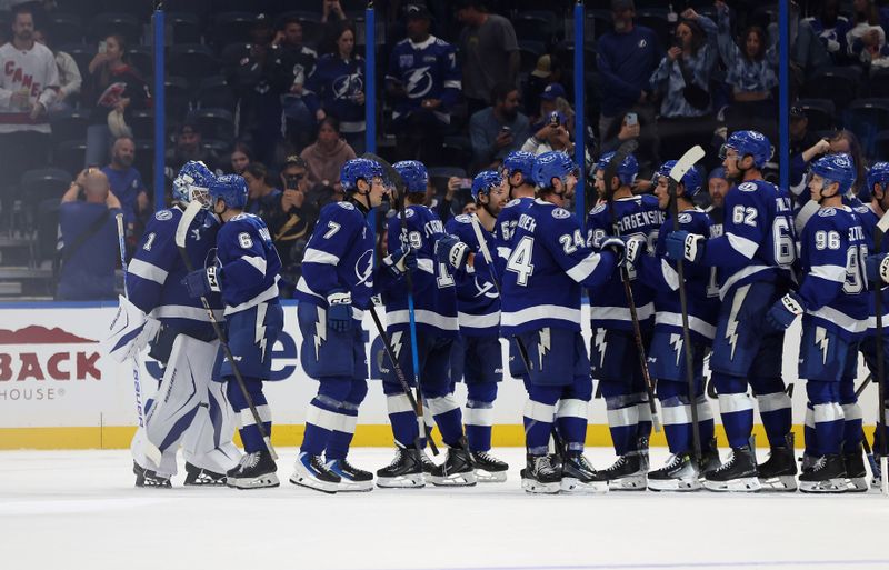 Sep 26, 2025; Tampa, Florida, USA; Tampa Bay Lightning goaltender Harrison Meneghin (1) center Nick Abruzzese (6) and teammates celebrate after they beat the Carolina Hurricanes at Benchmark International Arena. Mandatory Credit: Kim Klement Neitzel-Imagn Images
