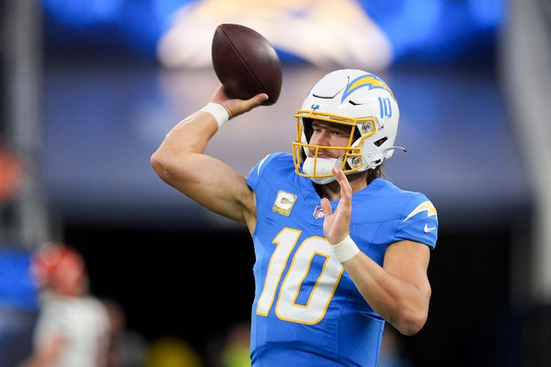 Los Angeles Chargers quarterback Justin Herbert (10) warms up before an NFL football game against the Cincinnati Bengals, Sunday, Nov. 17, 2024, in Inglewood, Calif. (AP Photo/Gregory Bull)