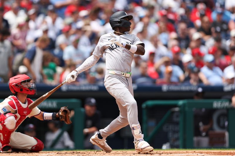 Jul 31, 2024; Philadelphia, Pennsylvania, USA;  New York Yankees third base Jazz Chisholm Jr. (13) hits a single during the second inning against the Philadelphia Phillies at Citizens Bank Park. Mandatory Credit: Bill Streicher-USA TODAY Sports