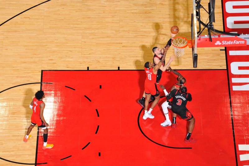 HOUSTON, TX - MARCH 21:   Nikola Vucevic #9 of the Chicago Bulls drives to the basket during the game against the Houston Rockets on March 21, 2024 at the Toyota Center in Houston, Texas. NOTE TO USER: User expressly acknowledges and agrees that, by downloading and or using this photograph, User is consenting to the terms and conditions of the Getty Images License Agreement. Mandatory Copyright Notice: Copyright 2024 NBAE (Photo by Logan Riely/NBAE via Getty Images)