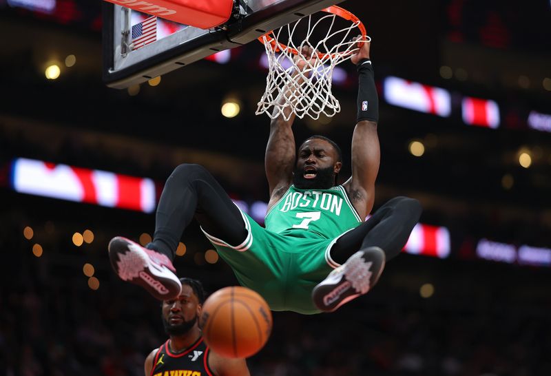 ATLANTA, GEORGIA - MARCH 28:  Jaylen Brown #7 of the Boston Celtics dunks against Bruno Fernando #24 of the Atlanta Hawks during the first quarter at State Farm Arena on March 28, 2024 in Atlanta, Georgia.  NOTE TO USER: User expressly acknowledges and agrees that, by downloading and/or using this photograph, user is consenting to the terms and conditions of the Getty Images License Agreement.  (Photo by Kevin C. Cox/Getty Images)