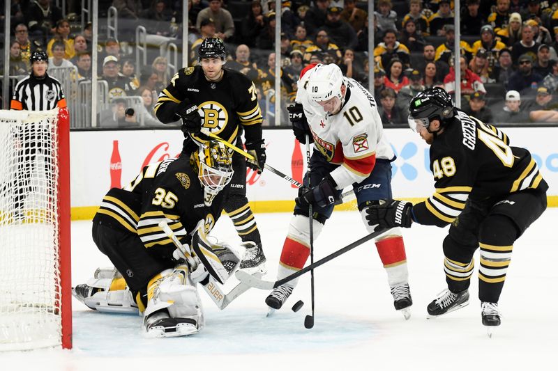 Apr 6, 2024; Boston, Massachusetts, USA; Florida Panthers right wing Vladimir Tarasenko (10) controls the puck in front of Boston Bruins goaltender Linus Ullmark (35) while defenseman Matt Grzelcyk (48) defends during overtime at TD Garden. Mandatory Credit: Bob DeChiara-USA TODAY Sports