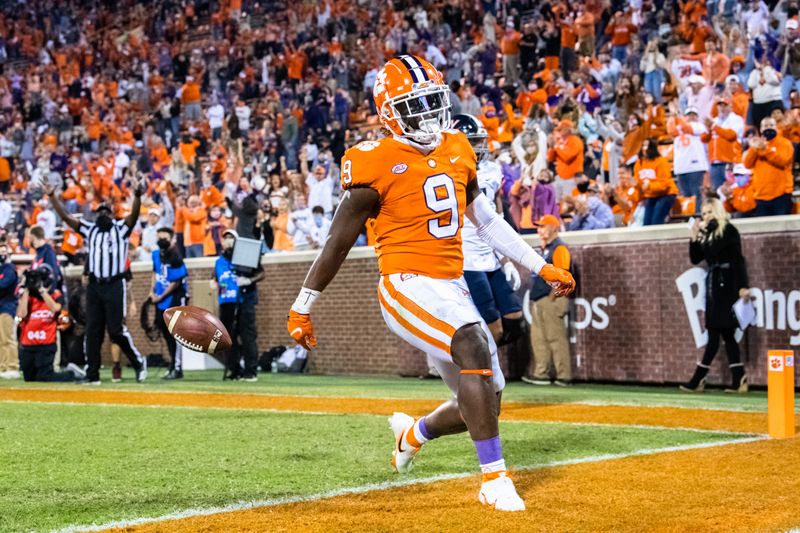  Oct 3, 2020; Clemson, South Carolina, USA; Clemson running back Travis Etienne (9) runs the ball in for a touchdown in the first quarter of their game against Virginia at Memorial Stadium. Mandatory Credit: Ken Ruinard-USA TODAY Sports