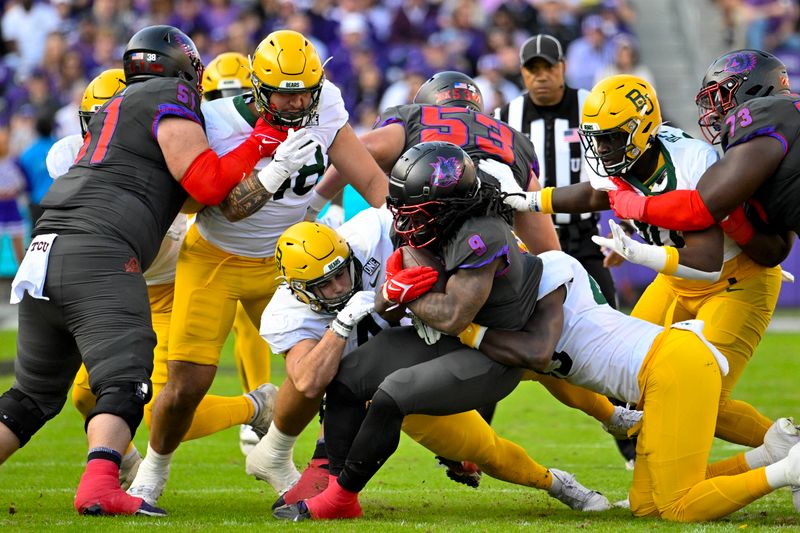 Nov 18, 2023; Fort Worth, Texas, USA; TCU Horned Frogs running back Emani Bailey (9) is tackled by the Baylor Bears defense during the first half at Amon G. Carter Stadium. Mandatory Credit: Jerome Miron-USA TODAY Sports