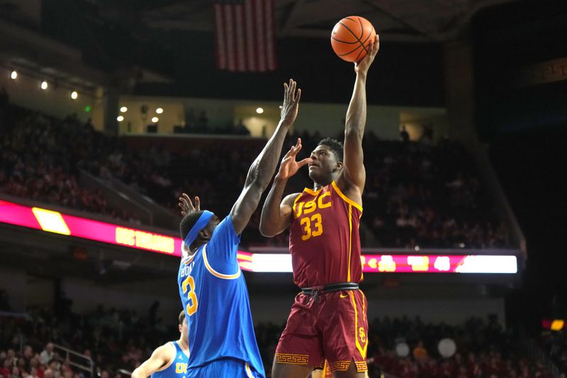 Jan 27, 2024; Los Angeles, California, USA; Southern California Trojans forward Kijani Wright (33) shoots the ball against UCLA Bruins forward Adem Bona (3) in the second half at Galen Center. Mandatory Credit: Kirby Lee-USA TODAY Sports