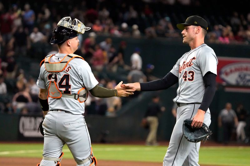 May 17, 2024; Phoenix, Arizona, USA; Detroit Tigers catcher Jake Rogers (34) and pitcher Joey Wentz (43) celebrate after defeating the Arizona Diamondbacks at Chase Field. Mandatory Credit: Rick Scuteri-USA TODAY Sports