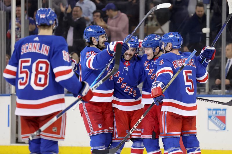 Mar 26, 2024; New York, New York, USA; New York Rangers defenseman Adam Fox (23) celebrates his game winning goal against the Philadelphia Flyers with left wing Chris Kreider (20) and center Vincent Trocheck (16) and defenseman Chad Ruhwedel (5) during overtime at Madison Square Garden. Mandatory Credit: Brad Penner-USA TODAY Sports