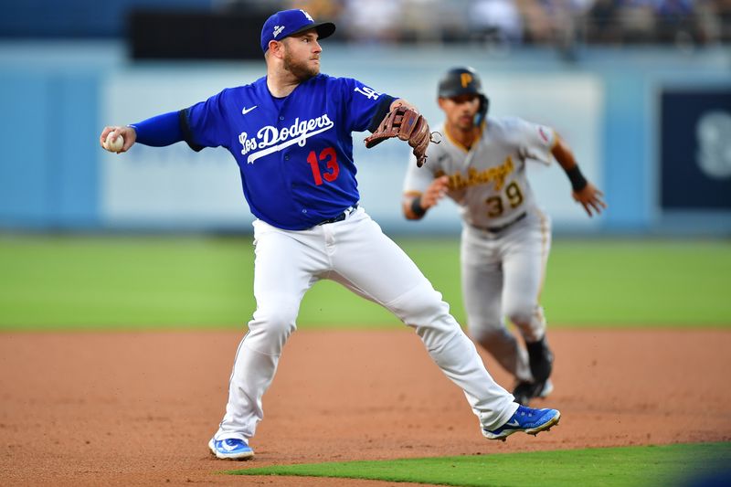 Jul 6, 2023; Los Angeles, California, USA; Los Angeles Dodgers third baseman Max Muncy (13) throws to first for the out against Pittsburgh Pirates catcher Jason Delay (55) during the second inning at Dodger Stadium. Mandatory Credit: Gary A. Vasquez-USA TODAY Sports