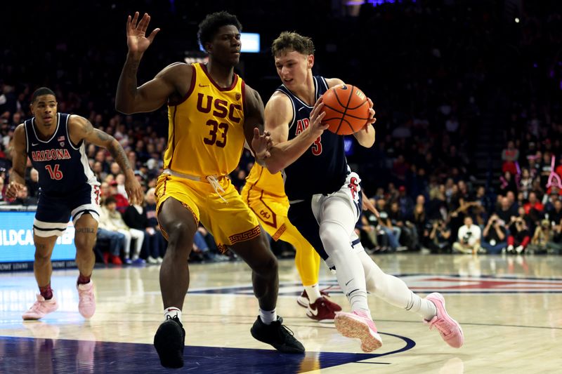 Jan 17, 2024; Tucson, Arizona, USA; Arizona Wildcats guard Pelle Larsson (3) drives to the net agaisnt USC Trojans forward Kijani Wright (33) during the second half at McKale Center. Mandatory Credit: Zachary BonDurant-USA TODAY Sports