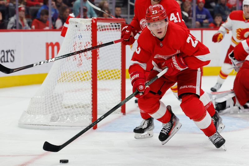 Oct 22, 2023; Detroit, Michigan, USA;  Detroit Red Wings left wing Lucas Raymond (23) skates with the puck in the first period against the Calgary Flames at Little Caesars Arena. Mandatory Credit: Rick Osentoski-USA TODAY Sports