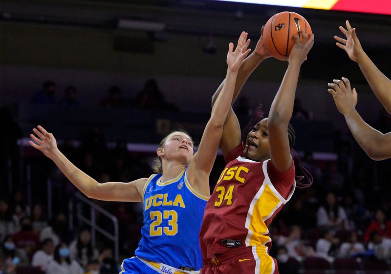 Dec 15, 2022; Los Angeles, California, USA;  USC Trojans center Clarice Akunwafo (34) beats UCLA Bruins forward Gabriela Jaquez (23) to a rebound in the second half at Galen Center. Mandatory Credit: Jayne Kamin-Oncea-USA TODAY Sports