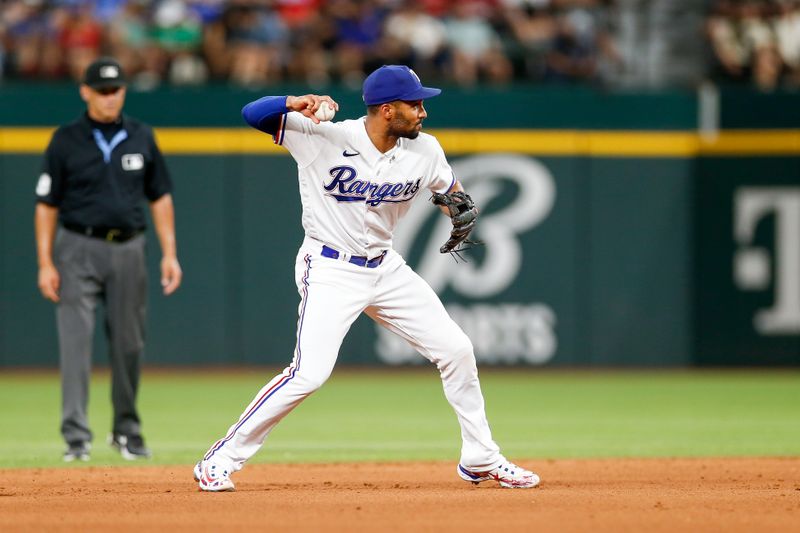 Aug 2, 2023; Arlington, Texas, USA; Texas Rangers second baseman Marcus Semien (2) throws over to first during the fifth inning against the Chicago White Sox at Globe Life Field. Mandatory Credit: Andrew Dieb-USA TODAY Sports