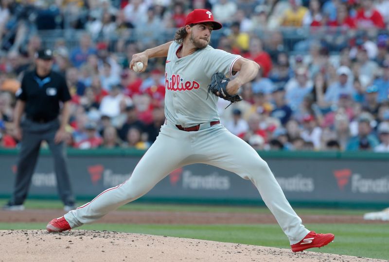 Jul 19, 2024; Pittsburgh, Pennsylvania, USA;  Philadelphia Phillies starting pitcher Aaron Nola (27) delivers a pitch against the Pittsburgh Pirates during the first inning at PNC Park. Mandatory Credit: Charles LeClaire-USA TODAY Sports