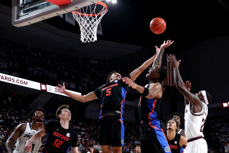 Jan 18, 2023; College Station, Texas, USA; Florida Gators guard Will Richard (5) grabs a rebound against the Texas A&M Aggies during the second half at Reed Arena. Mandatory Credit: Erik Williams-USA TODAY Sports
