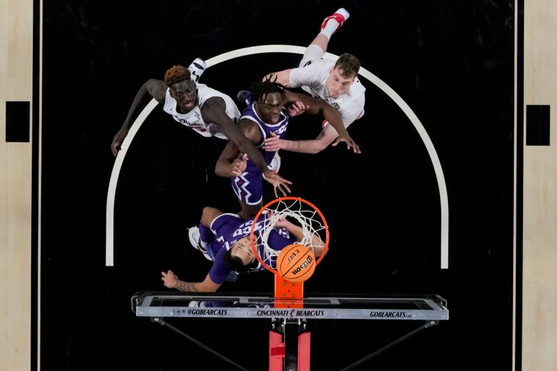 sJan 16, 2024; Cincinnati, Ohio, USA;  The Cincinnati Bearcats and the TCU Horned Frogs battle for a rebound in the second half at Fifth Third Arena. Mandatory Credit: Aaron Doster-USA TODAY Sports