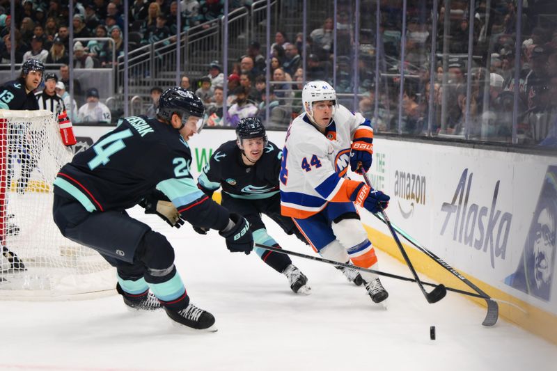 Nov 16, 2024; Seattle, Washington, USA; New York Islanders center Jean-Gabriel Pageau (44) plays the puck while defended by Seattle Kraken defenseman Jamie Oleksiak (24) and defenseman Will Borgen (3) during the second period at Climate Pledge Arena. Mandatory Credit: Steven Bisig-Imagn Images