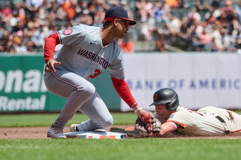 Apr 10, 2024; San Francisco, California, USA; San Francisco Giants shortstop Tyler Fitzgerald (49) slides headfirst into third base against Washington Nationals third baseman Trey Lipscomb (38) during the second inning at Oracle Park. Mandatory Credit: Robert Edwards-USA TODAY Sports