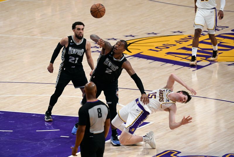 LOS ANGELES, CA - APRIL 22: Austin Reaves #15 of the Los Angeles Lakers flats after getting hit in the face by Xavier Tillman #2 of the Memphis Grizzlies during the second half of Round 1 Game 3 of the 2023 NBA Playoffs at Crypto.com Arena on April 22, 2023 in Los Angeles, California. NOTE TO USER: User expressly acknowledges and agrees that, by downloading and or using this photograph, User is consenting to the terms and conditions of the Getty Images License Agreement. (Photo by Kevork Djansezian/Getty Images)