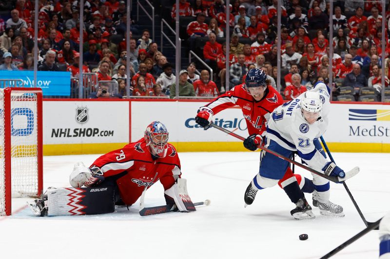 Apr 13, 2024; Washington, District of Columbia, USA; Tampa Bay Lightning center Brayden Point (21) and Washington Capitals center Nic Dowd (26) battles for the puck in front of Capitals goaltender Charlie Lindgren (79) in the second period at Capital One Arena. Mandatory Credit: Geoff Burke-USA TODAY Sports