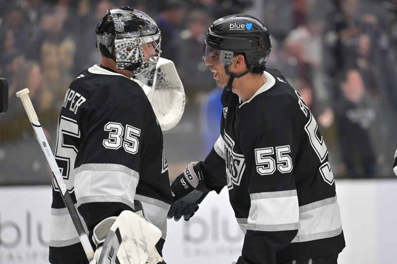 Jan 5, 2026; Los Angeles, California, USA; Los Angeles Kings goaltender Darcy Kuemper (35) is congratulated by right wing Quinton Byfield (55) after the game against the Minnesota Wild at Crypto.com Arena. Mandatory Credit: Jayne Kamin-Oncea-Imagn Images