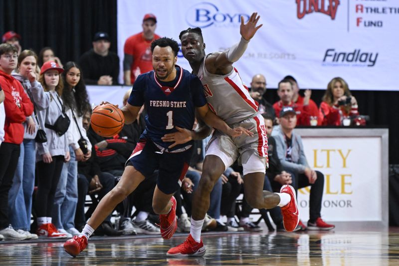 Feb 3, 2023; Las Vegas, Nevada, USA; Fresno State Bulldogs guard Jermarl Baker (1) is fouled by UNLV Runnin' Rebels forward Victor Iwuakor (0) in the second half at Thomas & Mack Center. Mandatory Credit: Candice Ward-USA TODAY Sports