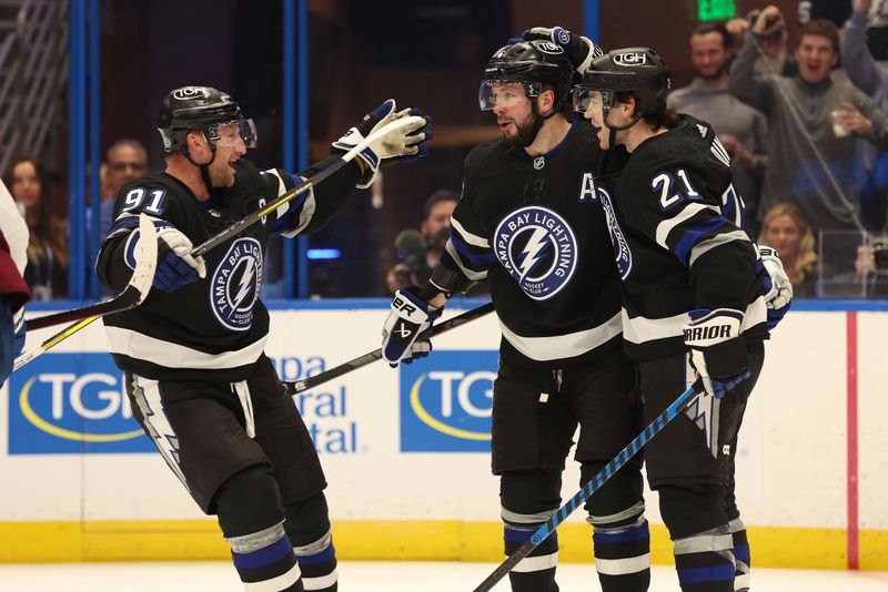 Feb 15, 2024; Tampa, Florida, USA; Tampa Bay Lightning right wing Nikita Kucherov (86) celebrates with  center Steven Stamkos (91) and center Brayden Point (21) after he scored a goal on Colorado Avalanche goaltender Justus Annunen (60) during the third period at Amalie Arena. Mandatory Credit: Kim Klement Neitzel-USA TODAY Sports