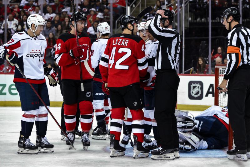 Nov 10, 2023; Newark, New Jersey, USA; New Jersey Devils center Curtis Lazar (42) talks with linesman Kilian McNamara (93) during the second period against the Washington Capitals at Prudential Center. Mandatory Credit: John Jones-USA TODAY Sports