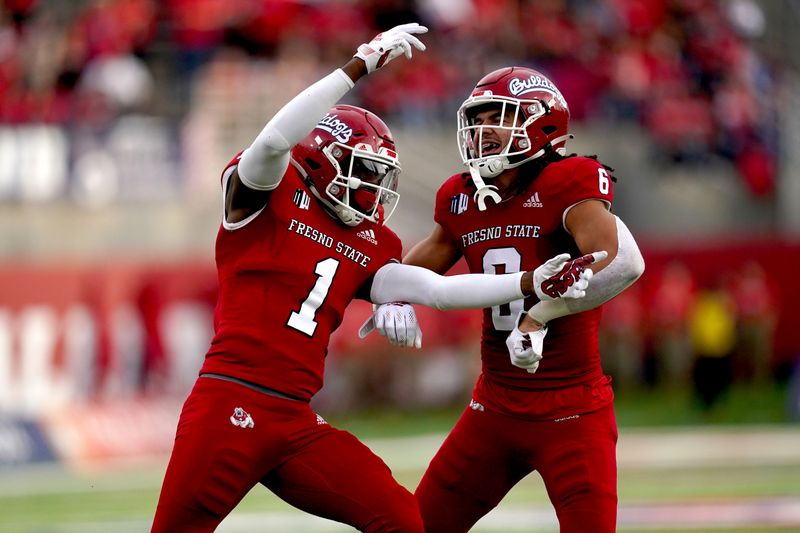 Oct 23, 2021; Fresno, California, USA; Fresno State Bulldogs defensive back Daron Bland (1) celebrates next to linebacker Levelle Bailey (6) after intercepting a pass against the Nevada Wolf Pack in the first quarter at Bulldog Stadium. Mandatory Credit: Cary Edmondson-USA TODAY Sports