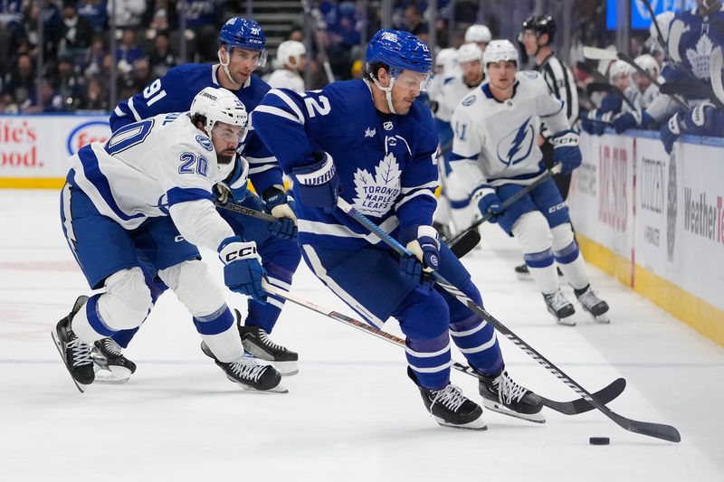 Apr 3, 2024; Toronto, Ontario, CAN; Toronto Maple Leafs defenseman Jake McCabe (22) carries the puck against he Tampa Bay Lightning during the first period at Scotiabank Arena. Mandatory Credit: John E. Sokolowski-USA TODAY Sports