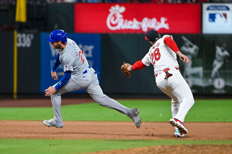 May 26, 2024; St. Louis, Missouri, USA;  St. Louis Cardinals third baseman Nolan Arenado (28) misses the tag on Chicago Cubs center fielder Cody Bellinger (24) but Bellinger was called out for running out of the base path during the fourth inning at Busch Stadium. Mandatory Credit: Jeff Curry-USA TODAY Sports