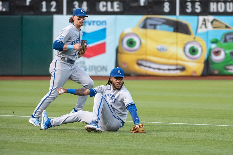 Aug 22, 2023; Oakland, California, USA; Kansas City Royals third baseman Maikel Garcia (11) slips while trying to field the ball during the third inning against the Oakland Athletics at Oakland-Alameda County Coliseum. Mandatory Credit: Ed Szczepanski-USA TODAY Sports