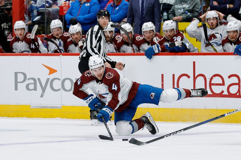 Feb 24, 2024; Denver, Colorado, USA; Colorado Avalanche defenseman Bowen Byram (4) falls to the ice as he keeps the puck in the zone in the second period against the Toronto Maple Leafs at Ball Arena. Mandatory Credit: Isaiah J. Downing-USA TODAY Sports