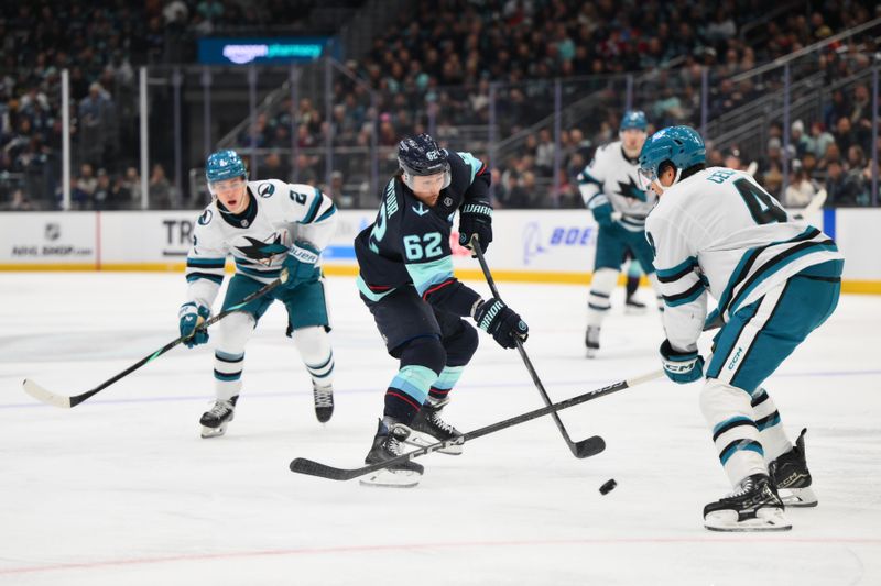 Nov 30, 2024; Seattle, Washington, USA; Seattle Kraken defenseman Brandon Montour (62) passes the puck while defended by San Jose Sharks defenseman Cody Ceci (4) during the second period at Climate Pledge Arena. Mandatory Credit: Steven Bisig-Imagn Images