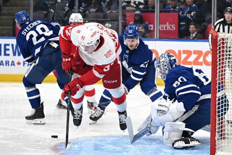 Jan 21, 2026; Toronto, Ontario, CAN; Toronto Maple Leafs goalie Joseph Woll (60) makes a save as Detroit Red Wings forward Marco Kasper (92) flies over the puck in the second period at Scotiabank Arena. Mandatory Credit: Dan Hamilton-Imagn Images