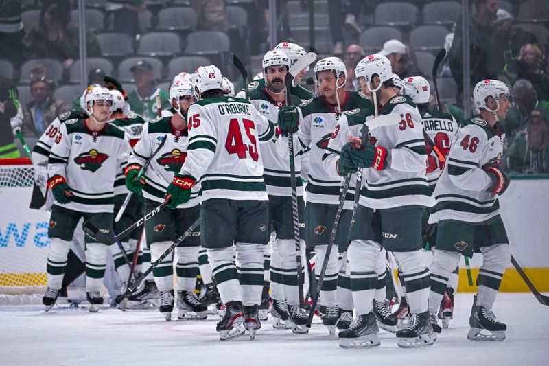 Sep 29, 2022; Dallas, Texas, USA; The Minnesota Wild celebrates getting the win over the Dallas Stars at the American Airlines Center. Mandatory Credit: Jerome Miron-USA TODAY Sports