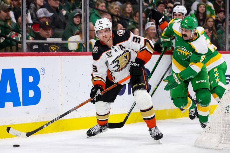 Jan 27, 2024; Saint Paul, Minnesota, USA; Anaheim Ducks right wing Jakob Silfverberg (33) passes as Minnesota Wild defenseman Jake Middleton (5) defends during the second period at Xcel Energy Center. Mandatory Credit: Matt Krohn-USA TODAY Sports