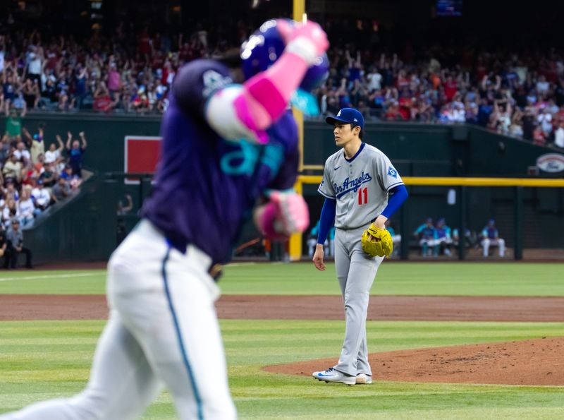 May 9, 2025; Phoenix, Arizona, USA; Los Angeles Dodgers pitcher Roki Sasaki reacts after giving up a home run to Arizona Diamondbacks infielder Ketel Marte in the first inning at Chase Field. Mandatory Credit: Mark J. Rebilas-Imagn Images