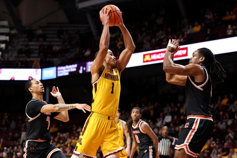 Dec 21, 2025; Minneapolis, Minnesota, USA; Minnesota Golden Gophers guard Isaac Asuma (1) drives to the basket as Campbell Fighting Camels forward Chris Fields Jr. (0) defends during the first half at Williams Arena. Mandatory Credit: Matt Krohn-Imagn Images