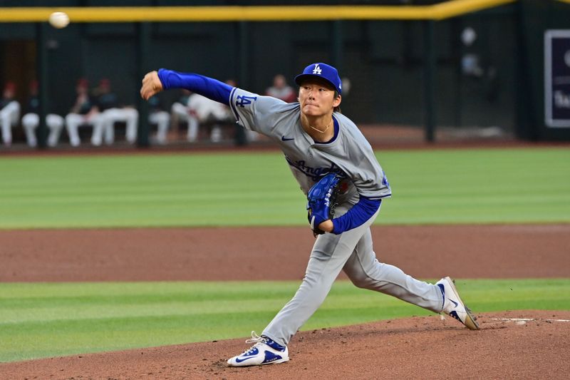 May 1, 2024; Phoenix, Arizona, USA;  Los Angeles Dodgers pitcher Yoshinobu Yamamoto (18) throws in the first inning against the Arizona Diamondbacks at Chase Field. Mandatory Credit: Matt Kartozian-USA TODAY Sports