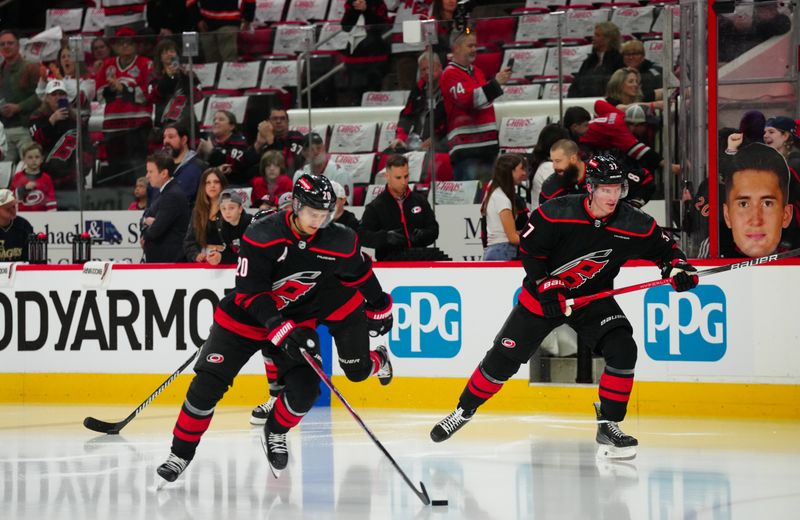 Apr 20, 2024; Raleigh, North Carolina, USA; Carolina Hurricanes center Sebastian Aho (20) and right wing Andrei Svechnikov (37) skate out onto the ice for the warmups before the game against the New York Islanders in game one of the first round of the 2024 Stanley Cup Playoffs at PNC Arena. Mandatory Credit: James Guillory-USA TODAY Sports