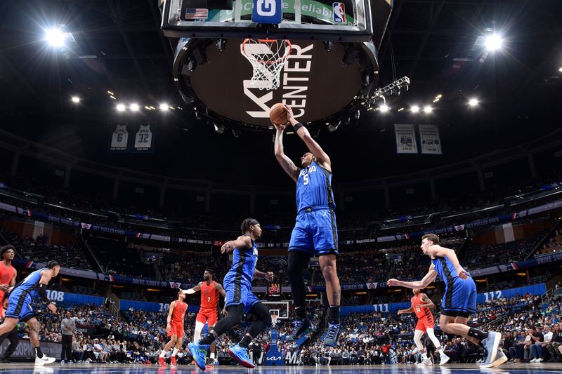 ORLANDO, FL - APRIL 1: Paolo Banchero #5 of the Orlando Magic grabs a rebound during the game against the Portland Trail Blazers on April 1, 2024 at Kia Center in Orlando, Florida. NOTE TO USER: User expressly acknowledges and agrees that, by downloading and or using this photograph, User is consenting to the terms and conditions of the Getty Images License Agreement. Mandatory Copyright Notice: Copyright 2024 NBAE (Photo by Fernando Medina/NBAE via Getty Images)