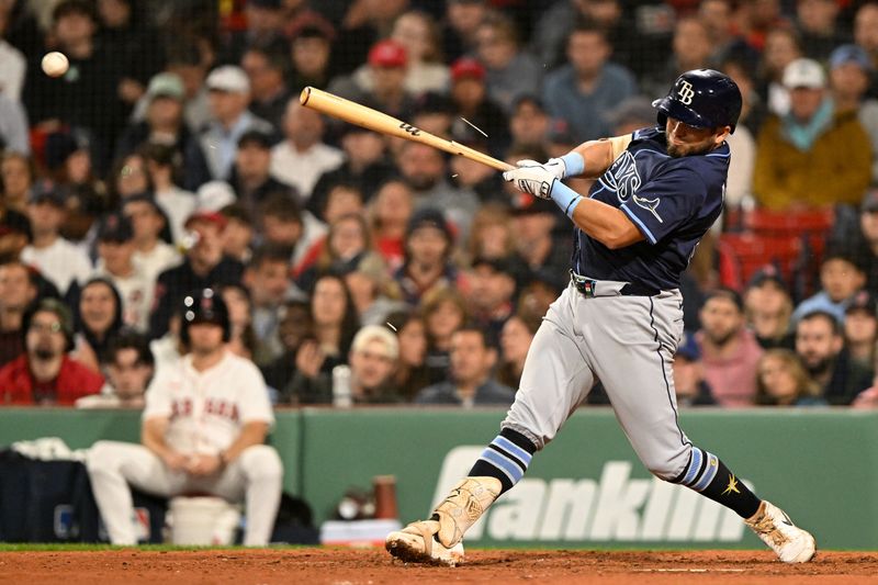 Jun 9, 2025; Boston, Massachusetts, USA; Tampa Bay Rays first baseman Jonathan Aranda (62) hits a RBI single against the Boston Red Sox during the seventh inning at Fenway Park. Mandatory Credit: Brian Fluharty-Imagn Images