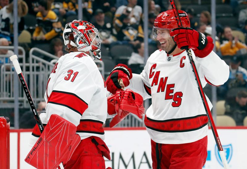 Oct 18, 2024; Pittsburgh, Pennsylvania, USA;  Carolina Hurricanes goaltender Frederik Andersen (31) and center Jordan Staal (11) celebrate after defeating the Pittsburgh Penguins at PPG Paints Arena. Mandatory Credit: Charles LeClaire-Imagn Images