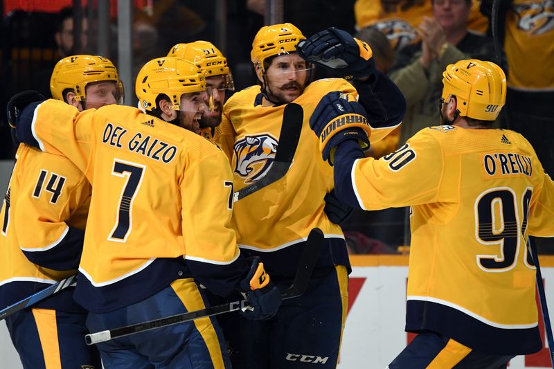 Nov 11, 2023; Nashville, Tennessee, USA; Nashville Predators left wing Filip Forsberg (9) celebrates with teammates after scoring to tie the game during the third period against the Arizona Coyotes at Bridgestone Arena. Mandatory Credit: Christopher Hanewinckel-USA TODAY Sports