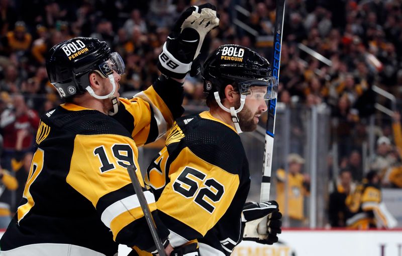 Feb 25, 2024; Pittsburgh, Pennsylvania, USA;  Pittsburgh Penguins right wing Reilly Smith (19) congratulates center  Emil Bemstrom (52) on his goal against the Philadelphia Flyers during the second period at PPG Paints Arena. Mandatory Credit: Charles LeClaire-USA TODAY Sports