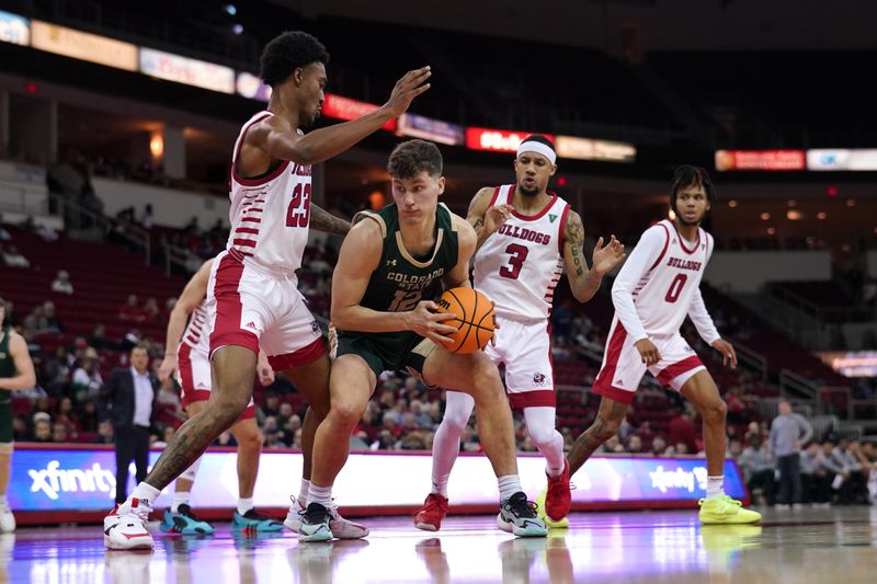 Feb 3, 2024; Fresno, California, USA; Colorado State Rams forward Patrick Cartier (12) holds onto the ball between Fresno State Bulldogs guard Leo Colimerio (23) and guard Isaiah Hill (3) in the first half at the Save Mart Center. Mandatory Credit: Cary Edmondson-USA TODAY Sports